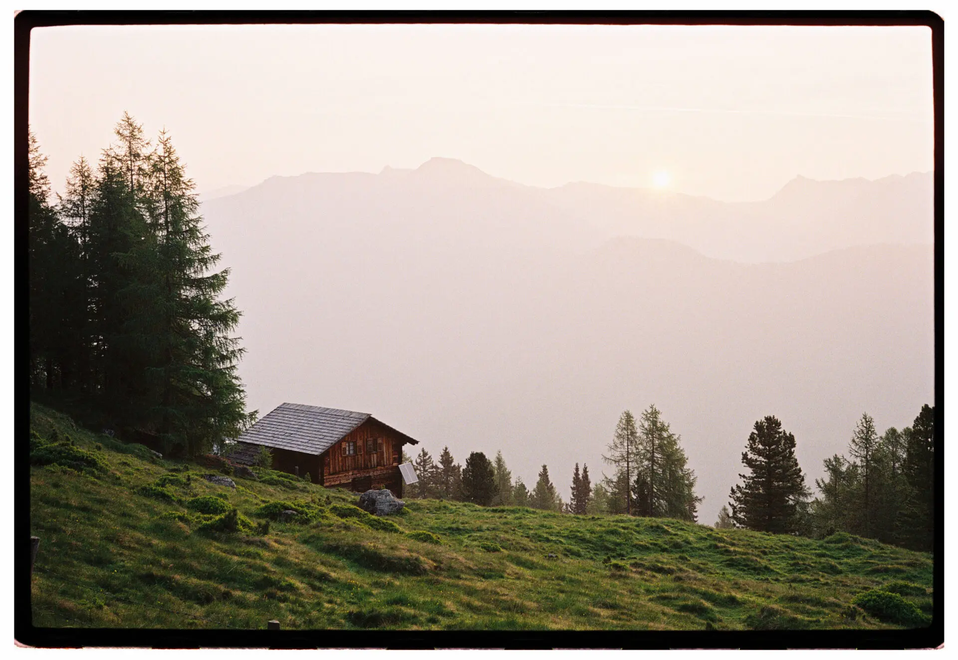 Wooden mountain cottage at dawn surrounded by alpine meadows in Carinthia, Austria